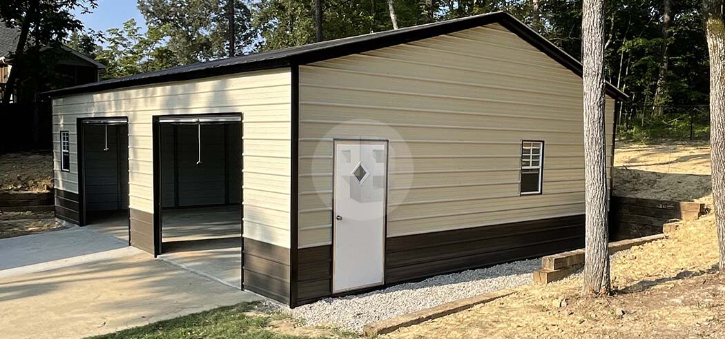 Two-bay tan metal garage with a black roof, brown wainscot and two open bay openings on the gable end